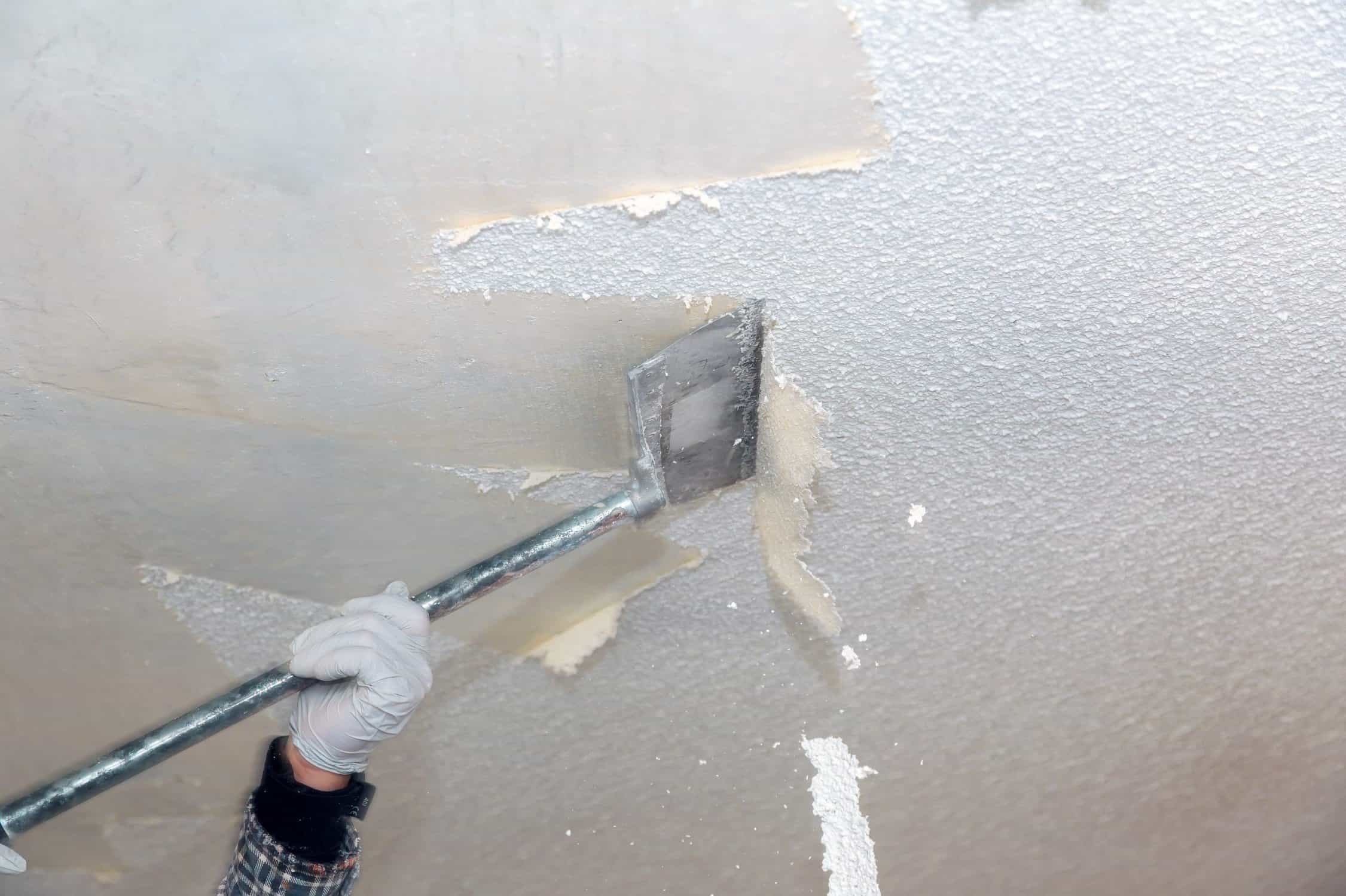 Popcorn ceiling being scraped