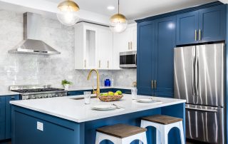 A blue kitchen with stainless steel appliances. grits for sanding cabinets