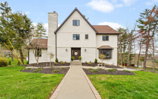 White brick siding and walls with long stone walkway, house trim exterior